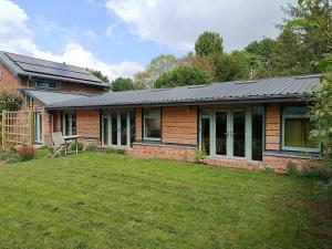 a house with solar panels on top of a yard at Lodge Two The Old Gasworks in Milverton