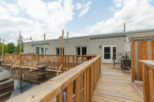 a large wooden deck in front of a house at #Le80ies - Downtown Rooftop - Free shuttle to ski Mountain in Mont-Tremblant