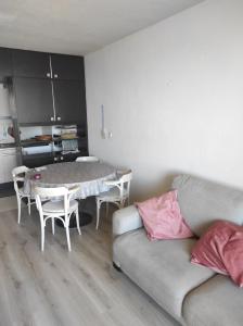 a living room with a couch and a table at Westdiep 602 zeezicht, verwarmd binnenzwembad in De Panne