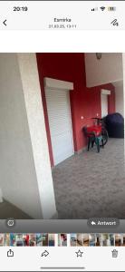 a room with a table and a red wall at Rastoder 2 in Donji Štoj