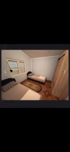 a small room with a bed and a window at Rastoder 2 in Donji Štoj