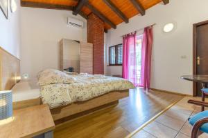 a bedroom with a bed and a table in a room at Casa Oliva in Klostar in Kloštar +25 photos