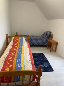 a bedroom with a bed with a colorful blanket at Maison de pêcheurs in Trégunc
