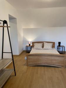 a bedroom with a large bed and two side tables at Maison de pêcheurs in Trégunc