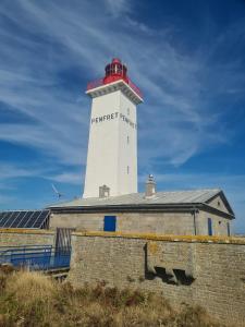 a lighthouse sitting on top of a building at Maison de pêcheurs in Trégunc
