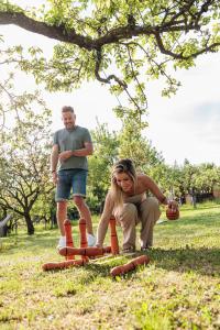 a man and a woman playing with orange cones at a Ficak in Miskolc