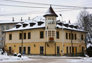 a building with a clock tower on top of it at Iris Villa in Vatra Dornei