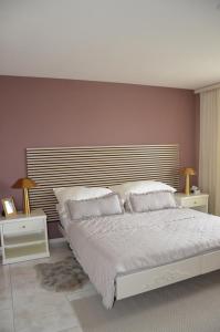a bedroom with a large bed with two night stands at Auszeitloge in Nottwil
