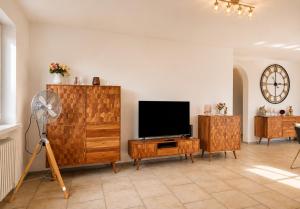 a living room with a television and a fan at Casa Di Napolitano 4 in Radolfzell am Bodensee