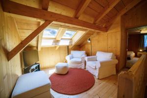 a room with two chairs and a television in a cabin at Chalet Lena - Managed by Hotel Gstaaderhof in Gstaad