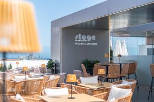 a rendering of a restaurant with tables and chairs at Occidental Las Palmas in Las Palmas de Gran Canaria