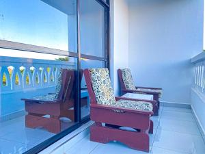 two chairs sitting on top of a balcony at The Safiya Hotel Apartments in Ukunda