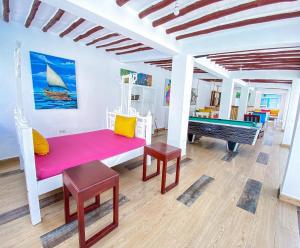 a living room with a bench and a piano at The Safiya Hotel Apartments in Ukunda