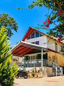a house with a motorcycle parked in front of it at Sunset Villa by Hyatt Stay in Avathi