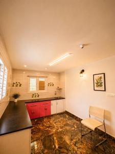 a kitchen with red cabinets and a counter top at Sunset Villa by Hyatt Stay in Avathi