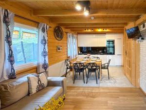 a kitchen and dining room with a table and chairs at Willa Wilk in Międzybrodzie Bialskie