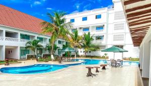 a hotel with a swimming pool and a building at The Safiya Hotel Apartments in Ukunda
