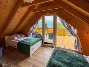 a bedroom with a bed and a window in a cabin at Willa Wilk in Międzybrodzie Bialskie +24 photos