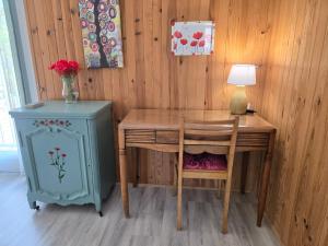 a desk with a chair and a table with a lamp at Villa Honorine in Saint-Honoré-les-Bains