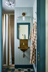 a bathroom with a sink and a mirror at Hotel Corduroy in Montauk +41 photos