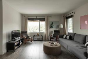 a living room with a couch and a coffee table at Downtown - FREE shuttle to Ski Resort - Ice Rink in Mont-Tremblant