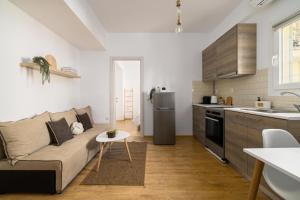 a living room with a couch and a kitchen at Ourania Lofts and Suites in Thessaloniki +22 photos
