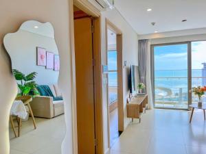 a hotel room with a view of a living room at CĂN HỘ CAO CẤP THE SONG VŨNG TÀU - LUXURY APARTMENT THE SÓNG VŨNG TÀUs in Vung Tau