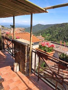 a balcony of a house with flowers on it at Attic with balcony at Locanda del Capo in Capannori