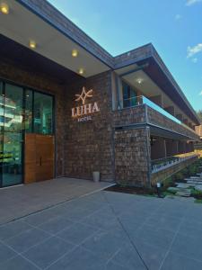 a building with a sign that reads jumeirah hotel at Hotel LUHA in Puerto Varas +21 photos