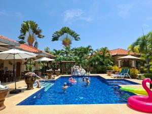 a group of people in a swimming pool at a resort at Stella Resort in Sam Roi Yot