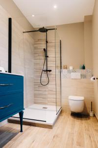 a bathroom with a glass shower and a toilet at La Villa du Sillon by les Ambassadeurs - Saint Malo Plage in Saint Malo +16 photos