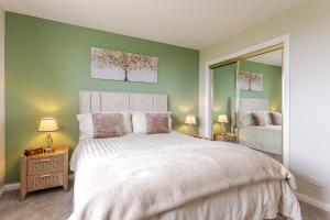 a bedroom with a large bed and a mirror at Seaview Bed & Breakfast in Isle of Lewis