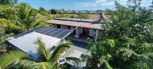 an aerial view of a house with solar panels on it at Open Kitchen Chiang Rai in Chiang Rai