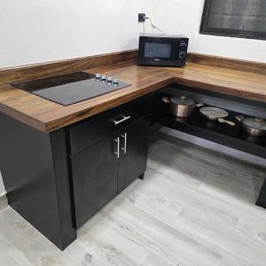 a kitchen counter with a sink and a microwave at Villa Libe Puerto Viejo in Puerto Viejo +28 photos
