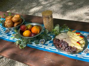 a table with two bowls of fruit and bread at Munich Oktoberfest on a Budget including breakfast in Munich +40 photos