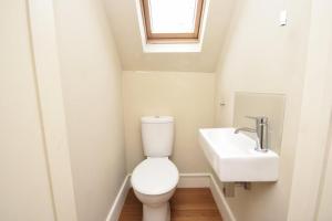 a bathroom with a toilet and a sink at Flat 4, 15 Ethelbert Square CT8 8SR in Westgate-on-Sea
