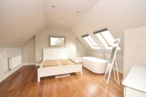 a bathroom with a bed and a bath tub and a sink at Flat 4, 15 Ethelbert Square CT8 8SR in Westgate-on-Sea