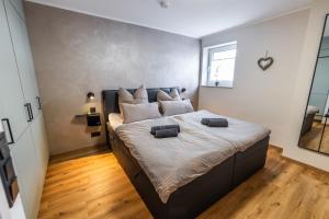 a bedroom with a large bed with two pillows on it at Eifel Comfort Luxury Spa Suite mit privatem Whirlpool & Sauna in Pronsfeld