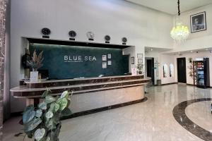 a blue sea sign on a wall in a lobby at Blue Sea Le Printemps in Marrakesh
