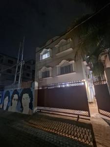 a building with a mural of faces on it at night at Nahor Residency in Guwahati