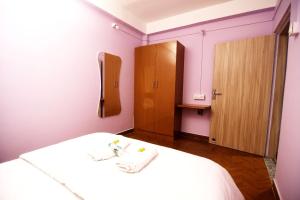 a small room with a bed and a cabinet at Nahor Residency in Guwahati
