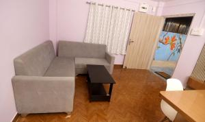 a living room with a couch and a table at Nahor Residency in Guwahati