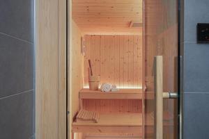 a wooden sauna in a bathroom with a shower at Candia Lux in Heraklio