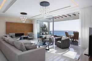 a living room with a couch and chairs and a table at Candia Lux in Heraklio