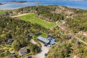 an aerial view of a house on a hill next to the water at Hakefjorden by Workershotel in Källsby