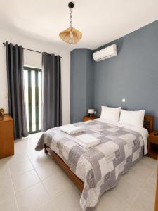 a bedroom with a large bed and a window at 4Seasons Sfakia in Hora Sfakion