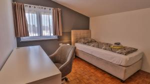a small bedroom with a bed and a chair at Sonnengarten floor 2 in Marčana +14 photos