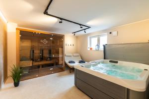 a large bathroom with a large tub in it at Eifel Comfort Luxury Spa Suite mit privatem Whirlpool & Sauna in Pronsfeld