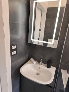 a bathroom with a sink and a mirror at Agli Archi Eco House in Chieti +28 photos