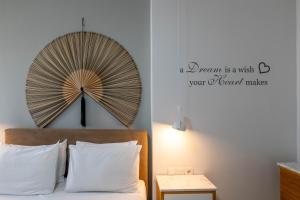 a bedroom with a large fan above a bed at A Comfortable Stay with Balcony and Easy Parking near Kalamata Center in Kalamata +63 photos